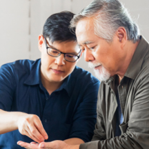 father and son with heads together