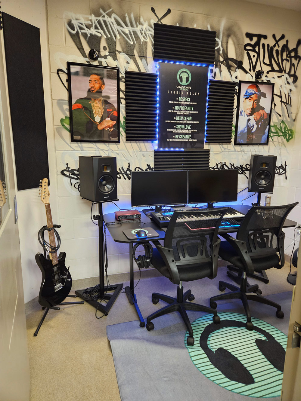 The music studio features a digital audio workstation with integrated keyboard, microphone, speakers, and monitors.