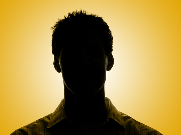 Silhouette of a person against a bright yellow background.