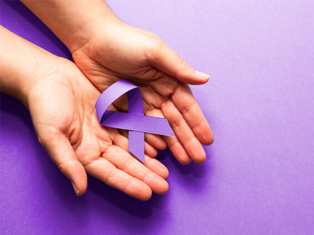 hands holding a purple ribbon