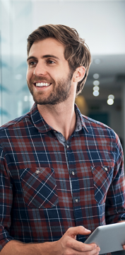 guy smiling holding a tablet