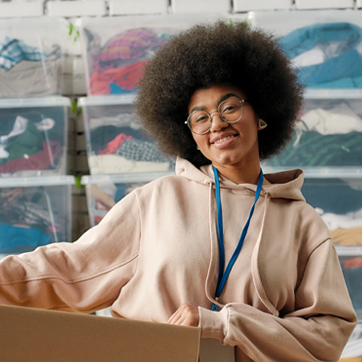 women holding cardboard box
