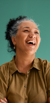 women laughing in front of a green background