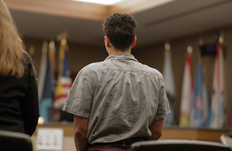 person standing in court with back to camera 