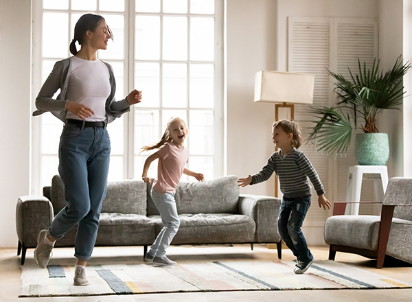 Mom and kids dancing inside