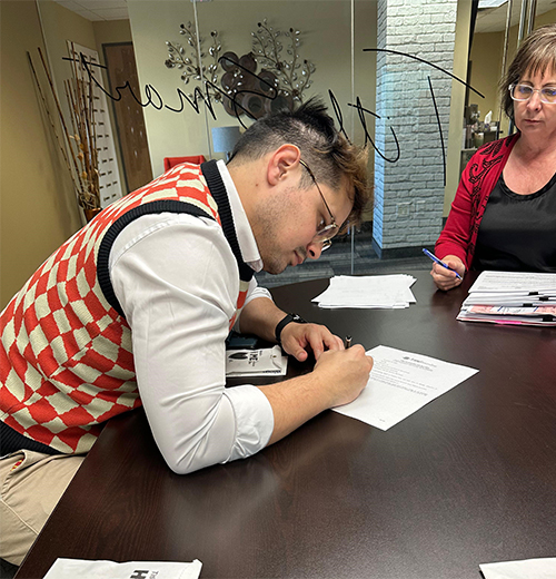 new homeowner signing papers in an office