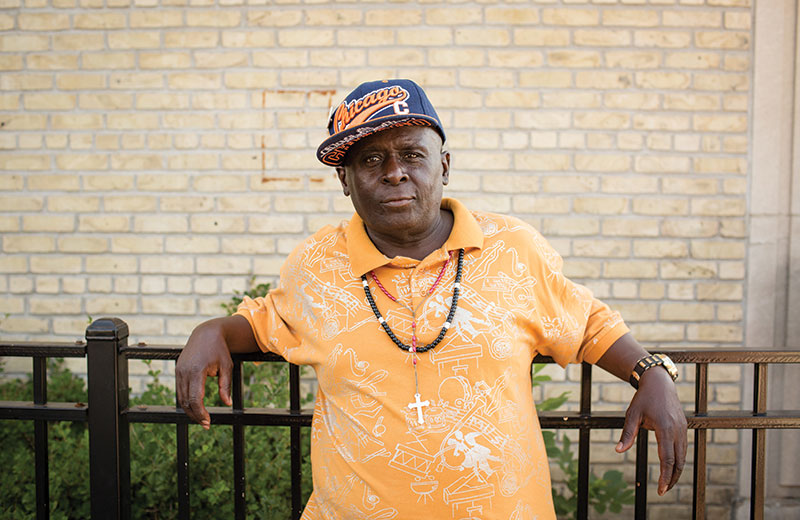man standing outside apartment building