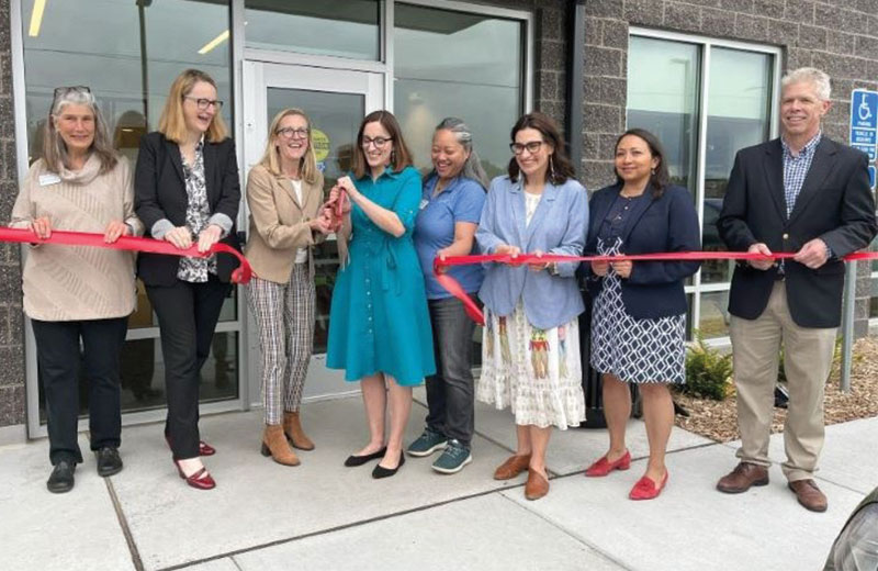 ribbon cutting outside of rise on seven