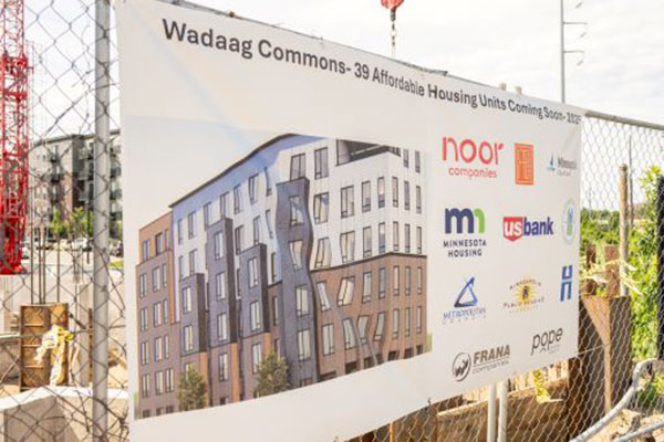 sign of the wadaag building on a fence outside