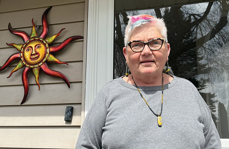 women standing outside her home