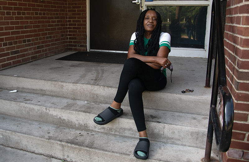 women sitting on front steps outside