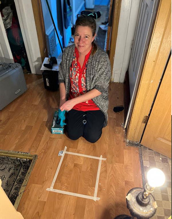 women on her knees testing the hardwood floor for lead